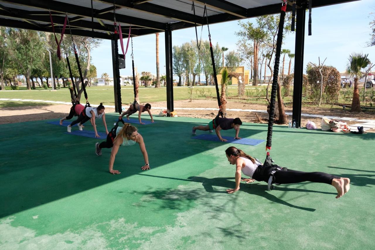Hotel Lara Barut Collection Antalya Exterior foto A group of women doing yoga at the park